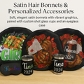 Satin hair bonnets with vibrant graphics, shot glass cups, and an eyeglass case on a wooden surface.